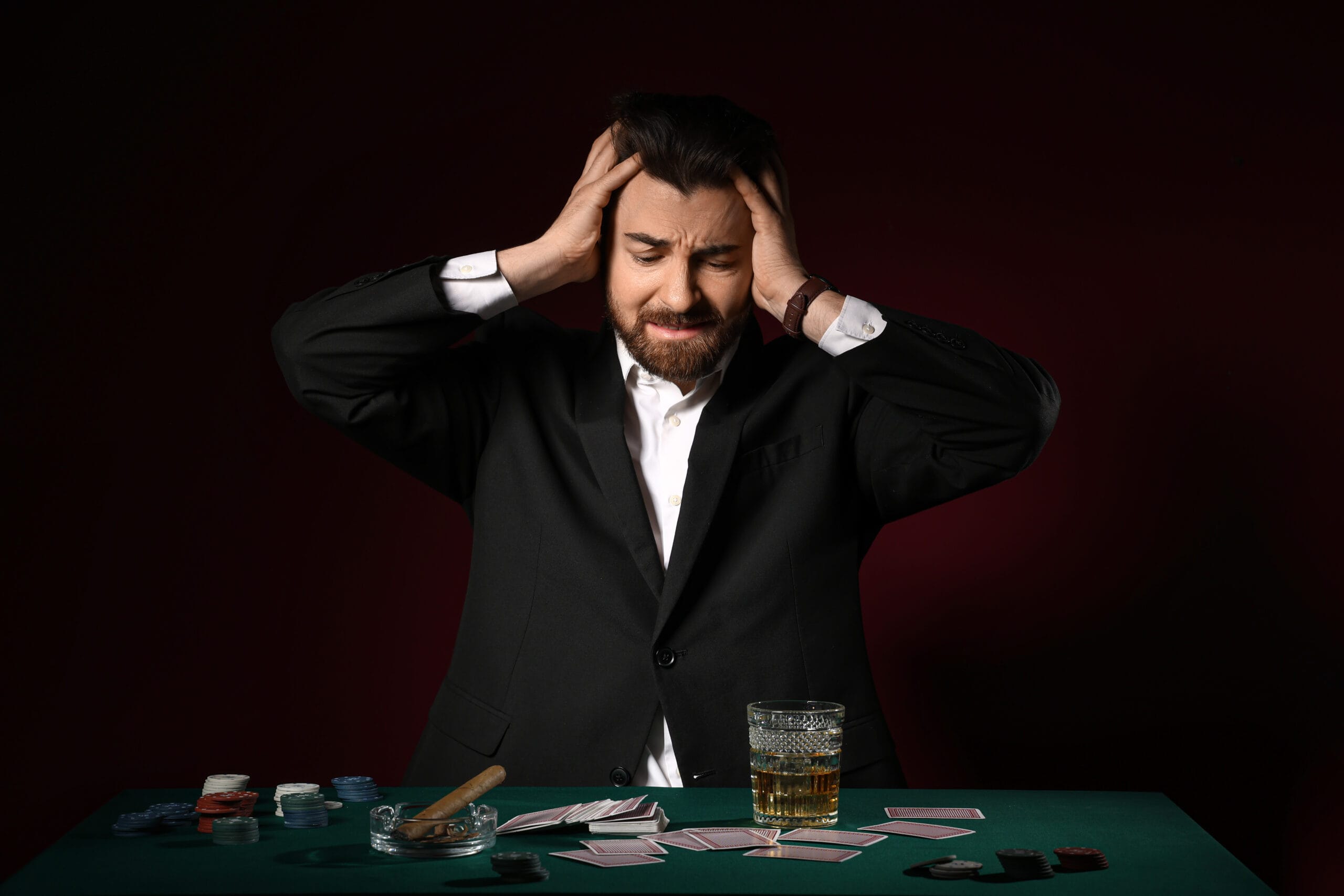 Stressed young man after losing at poker in casino